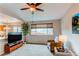 Bright living room featuring a TV, large window, and comfortable seating at 10652 Hyacinth St, Highlands Ranch, CO 80129