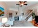 Comfortable living room featuring a fireplace and easy access to the staircase at 10652 Hyacinth St, Highlands Ranch, CO 80129