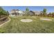 A spacious lawn and landscaping define this backyard, with a patio for entertaining and white fencing at 405 Buckskin Rd, Berthoud, CO 80513