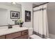 Bathroom featuring granite countertops, modern fixtures, and neutral-toned tile in the shower at 405 Buckskin Rd, Berthoud, CO 80513