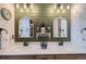 Bathroom featuring double sinks with farmhouse mirrors and stylish shiplap accents at 405 Buckskin Rd, Berthoud, CO 80513