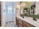 Charming bathroom with double vanity, farmhouse mirror, and stylish green shiplap wall at 405 Buckskin Rd, Berthoud, CO 80513