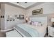 Comfortable bedroom featuring a white bed, patterned wallpaper, and decorative wall art at 405 Buckskin Rd, Berthoud, CO 80513