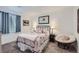 Cozy bedroom with a decorative quilt, comfortable chair, and soft natural light at 405 Buckskin Rd, Berthoud, CO 80513