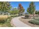Sidewalk leads to a community park area with mature trees, playground equipment, and green spaces at 405 Buckskin Rd, Berthoud, CO 80513