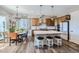 Bright dining area features a sliding glass door, a modern chandelier and seating for four at 405 Buckskin Rd, Berthoud, CO 80513