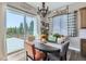 Sunny dining area features a sliding glass door to the backyard and stylish decor at 405 Buckskin Rd, Berthoud, CO 80513