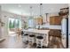 Beautiful eat-in kitchen features pendant lighting, stainless appliances and a sliding glass door to the backyard at 405 Buckskin Rd, Berthoud, CO 80513