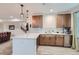 This kitchenette features wooden cabinets, white quartz countertops, and wood-look tile floors at 405 Buckskin Rd, Berthoud, CO 80513