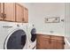 Functional laundry room with modern washer and dryer units and ample cabinet space at 405 Buckskin Rd, Berthoud, CO 80513