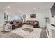 Comfortable living room with brown leather couches, patterned pillows, and a decorative area rug at 405 Buckskin Rd, Berthoud, CO 80513