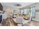 Inviting living room featuring hardwood floors, a fireplace, and stylish farmhouse-style décor at 405 Buckskin Rd, Berthoud, CO 80513