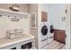 Mud room featuring a built-in bench with storage and direct access to the laundry area at 405 Buckskin Rd, Berthoud, CO 80513