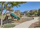 Wooden playground structure at the community park with green slide, picnic table, and sidewalks at 405 Buckskin Rd, Berthoud, CO 80513