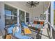 Relaxing covered porch with comfortable seating and hanging swing at 405 Buckskin Rd, Berthoud, CO 80513
