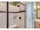 Modern bathroom shower with white subway tile, black accents, and a built-in bench at 405 Buckskin Rd, Berthoud, CO 80513
