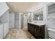 Bathroom featuring a vanity with dark cabinets, tile floor, and a shower with glass door at 904 Clover Cir, Lafayette, CO 80026
