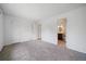 Neutral bedroom leading to bathroom, with carpet and natural light at 904 Clover Cir, Lafayette, CO 80026