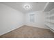 Neutral bedroom with carpet, window, and shelving unit at 904 Clover Cir, Lafayette, CO 80026