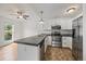 Bright kitchen boasts stainless steel appliances, a gray countertop, and white cabinets at 904 Clover Cir, Lafayette, CO 80026