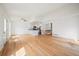 Bright and airy living space featuring beautiful wood floors, white walls, a modern, stainless steel kitchen, and ceiling fan at 904 Clover Cir, Lafayette, CO 80026