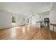 Bright and airy living space featuring beautiful wood floors, white walls, a modern, stainless steel kitchen, and ceiling fan at 904 Clover Cir, Lafayette, CO 80026