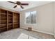 Spacious bedroom with built-in shelves and neutral carpeting at 1820 Cooper Ct, Castle Rock, CO 80109