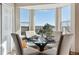 Bright dining area with a glass table and stunning views from the large windows at 1820 Cooper Ct, Castle Rock, CO 80109