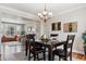 Spacious dining room with hardwood floors, chandelier, and view to living room at 1820 Cooper Ct, Castle Rock, CO 80109