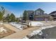 Two-story house with gray siding, attached garage, and a landscaped yard at 1820 Cooper Ct, Castle Rock, CO 80109