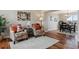 Bright living room with hardwood floors, comfortable chairs, and view to dining area at 1820 Cooper Ct, Castle Rock, CO 80109