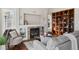 Cozy living room with fireplace, built-in shelving, and hardwood floors at 1820 Cooper Ct, Castle Rock, CO 80109