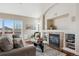 Living room with fireplace, hardwood floors, and access to deck with scenic views at 1820 Cooper Ct, Castle Rock, CO 80109