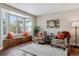 Living room with bay window, built-in window seat, and hardwood floors at 1820 Cooper Ct, Castle Rock, CO 80109