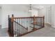 Upstairs hallway with wood railing and neutral carpeting at 1820 Cooper Ct, Castle Rock, CO 80109