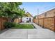 Charming backyard features a well-manicured lawn and modern wood fence at 1024 W 8Th Ave, Denver, CO 80204