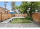 Spacious backyard with healthy lawn, stepping stones, and privacy fence at 1024 W 8Th Ave, Denver, CO 80204