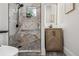 Modern bathroom with marbled shower, herringbone vanity, and stylish fixtures at 1024 W 8Th Ave, Denver, CO 80204