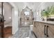 Bright modern bathroom with shower, herringbone vanity, and gray tiled floors at 1024 W 8Th Ave, Denver, CO 80204