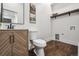Updated half bathroom with modern vanity, stylish mirror, and wood flooring at 1024 W 8Th Ave, Denver, CO 80204