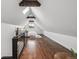 Spacious bedroom with wood floors, skylight, wood beams, and a black railing at 1024 W 8Th Ave, Denver, CO 80204