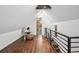 Bedroom with hardwood floors, a skylight, wood beams, and access to the bathroom at 1024 W 8Th Ave, Denver, CO 80204