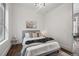 Comfortable bedroom with natural light, hardwood floors, and minimalist decor at 1024 W 8Th Ave, Denver, CO 80204