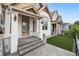 Inviting front porch with stone steps and decorative columns, showcasing curb appeal at 1024 W 8Th Ave, Denver, CO 80204