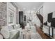 Open-concept living room features exposed brick, modern kitchen, and staircase access at 1024 W 8Th Ave, Denver, CO 80204