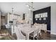 Elegant kitchen and dining area with white cabinets, granite countertops, and stylish pendant lighting at 6712 Zuni St, Denver, CO 80221