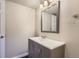 Bathroom vanity with gray cabinets, white countertop, framed mirror, and modern fixtures at 3539 S Fairplay Way # 10, Aurora, CO 80014