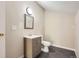 This bathroom offers a modern vanity, square mirror, and toilet, with a light fixture above at 3539 S Fairplay Way # 10, Aurora, CO 80014