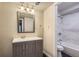 Bathroom with dual sink vanity, framed mirror, and shower over tub at 3539 S Fairplay Way # 10, Aurora, CO 80014