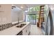 Modern kitchen featuring white cabinets, quartz countertops, and stainless steel appliances with wood floors at 3539 S Fairplay Way # 10, Aurora, CO 80014